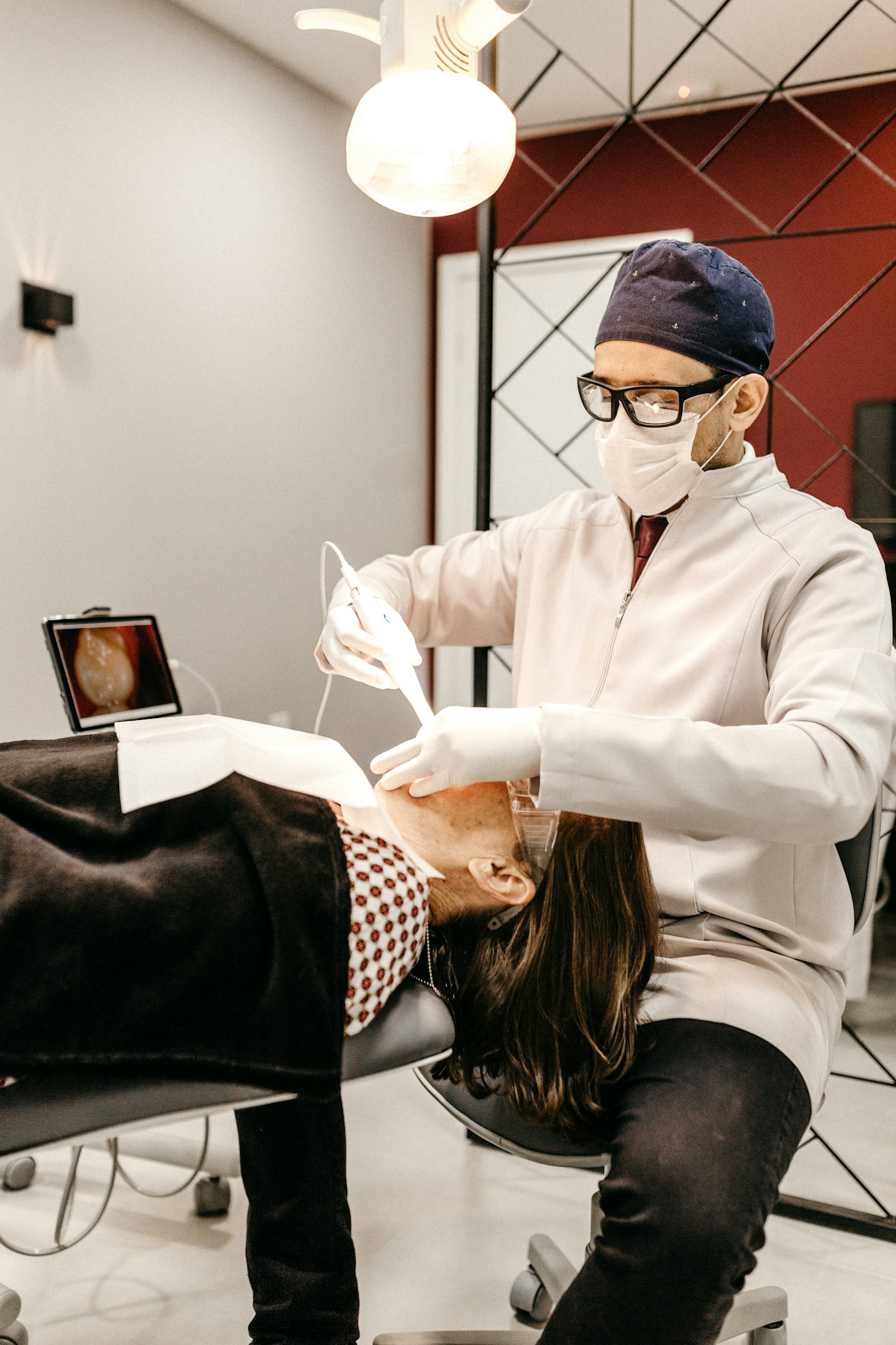 AI receptionist for dentists answering patient messages while the dentist treats a patient