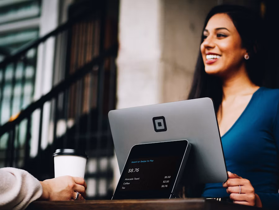 Woman working on laptop at a coffee counter