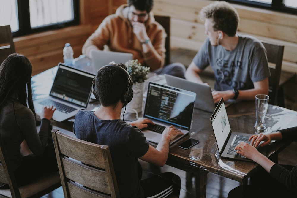 Team collaborating around a laptop