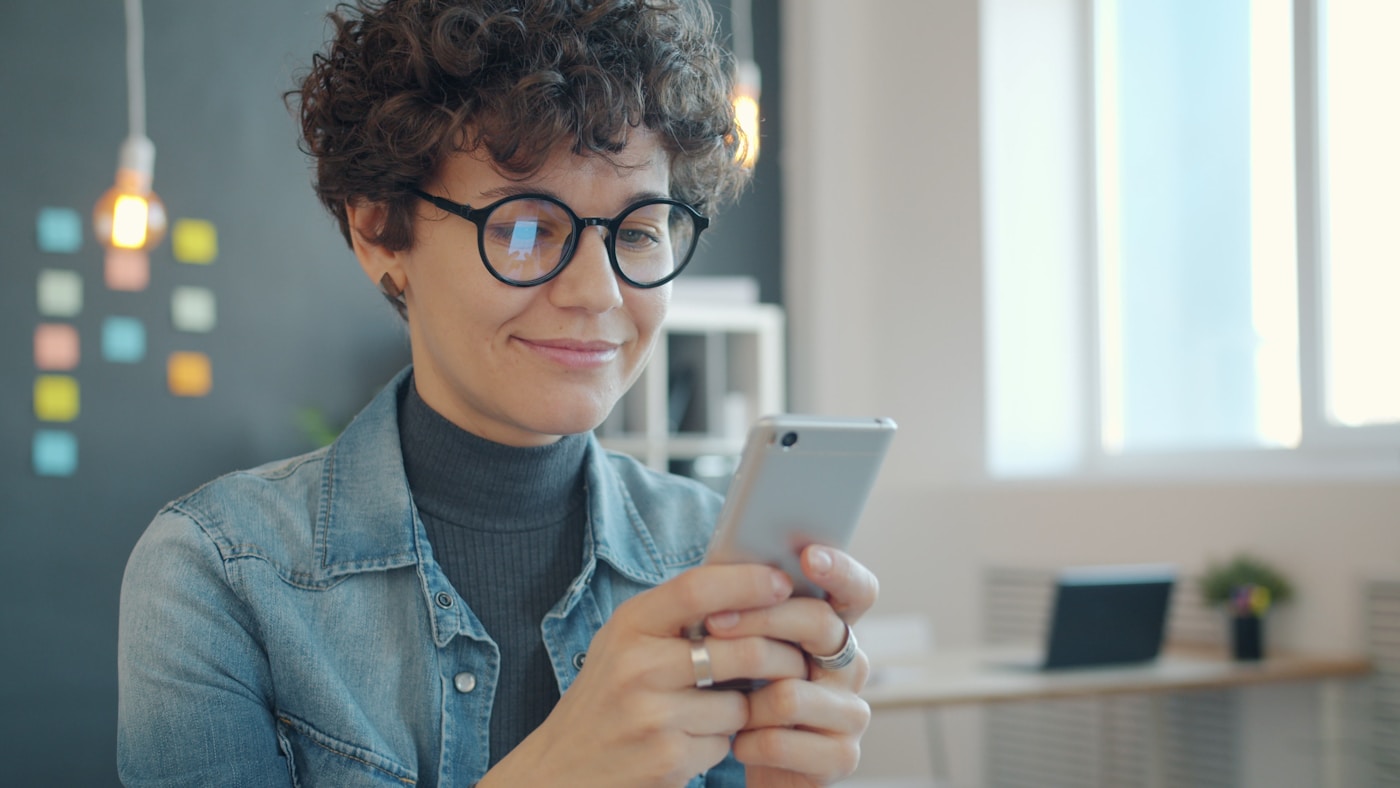Happy customer leaving a five-star review on their phone after using a review generation service
