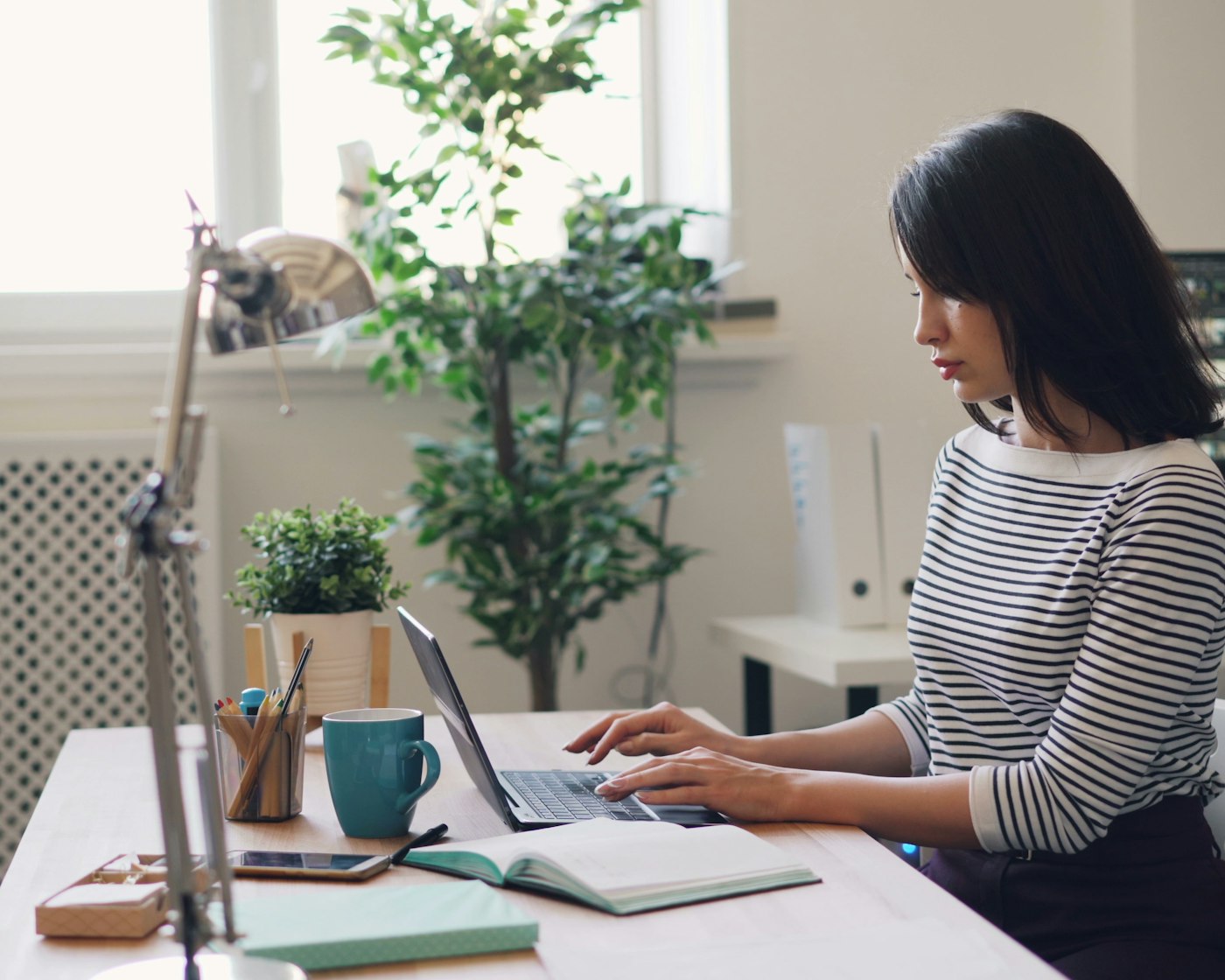 Accountant working at a laptop, the kind of filing question a virtual assistant for accountants answers first during tax season