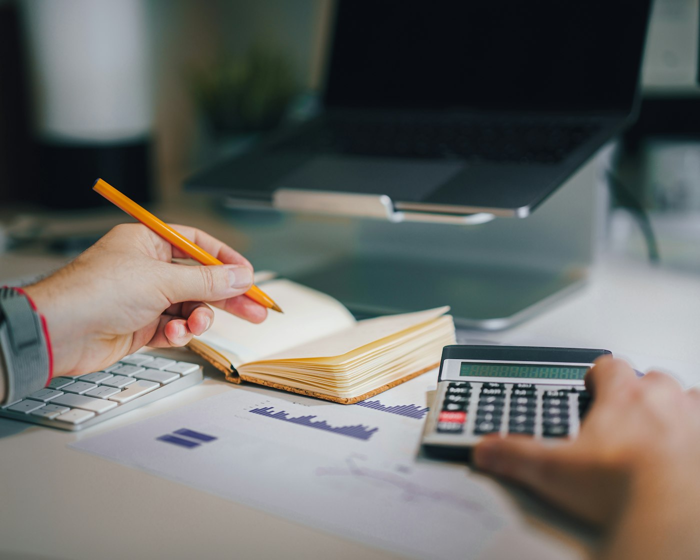 Bookkeeper reviewing receipts and a calculator, the kind of client message a virtual assistant for bookkeeping answers first